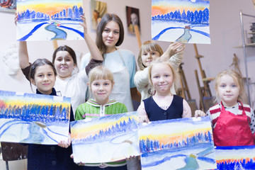 Children show their work on drawing