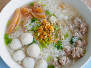 Rice porridge with shrimp, fish ball, pork, crispy squid, coriander, spring onion, pepper powder