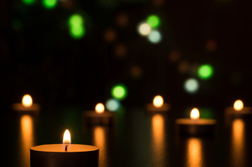 Candles with light in a romantic decoration and defocused lights. Bokeh effect