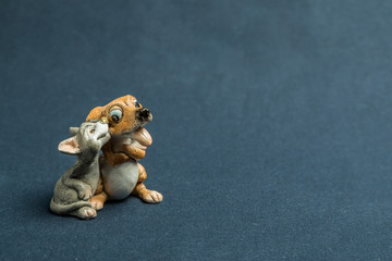 Mongrel and cat against a dark background