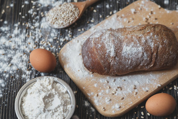 Above view of a rustic loaf  bread on an old wooden table.