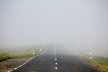 Empty long highway with fog