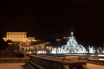 Fountain "Alexandru Ioan Cuza" lighted and ornaments in front of the building Casa Presei Libere, night time