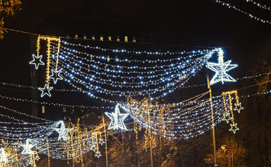 Colored Christmas lights and ornaments, stars and snowflakes in downtown Bucharest