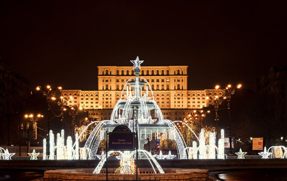 Fountain "Alexandru Ioan Cuza" lighted and ornaments in front of the building Casa Presei Libere, night time