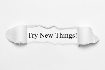 Fototapeta premium Try New Things! on white torn paper