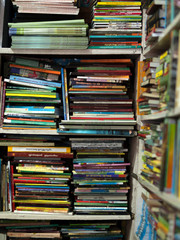 COLOR PHOTO OF BOOKS CRAMMED IN BOOKSHELF