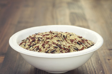 rice in white plate on wooden background