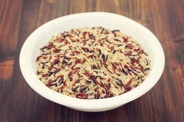 rice in white plate on wooden background