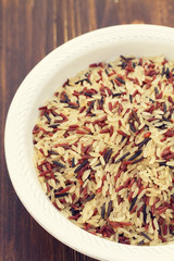 rice in white plate on wooden background