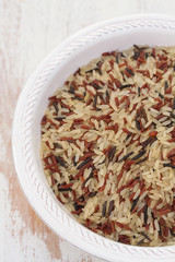 rice in white plate on wooden background