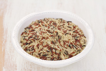 rice in white plate on wooden background