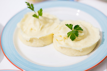 Mashed potatoes on plate.