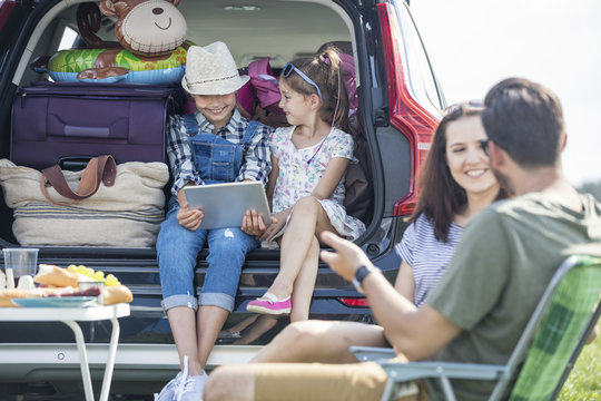 Happy family on a road trip taking a break at the road side