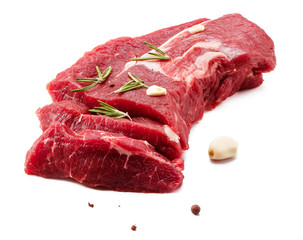 Pieces of meat with garlic and rosemary isolated on white background. Raw beef.