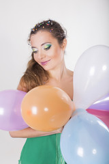 Brunette Woman Holding Balloons on her Birthday Party and Smiling