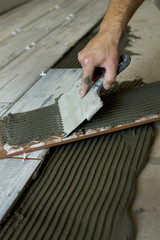 Worker installing Tiles on the Floor