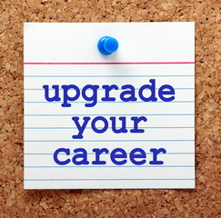 Fototapeta premium The words Upgrade Your Career in blue text on a note card pinned to a cork notice board as a reminder to progress in your employment