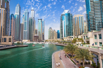Fototapeta na wymiar Promenade and canal in Dubai Marina with luxury skyscrapers around,United Arab Emirates