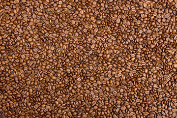 Coffee background. Heap coffee beans over on table.