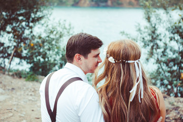 lovers sitting by the water on the bench