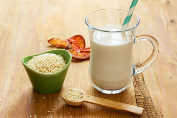 Sesame seed milk in a glass. White sesame seeds.