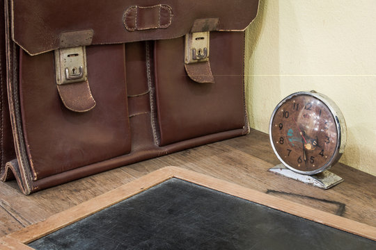 Brown Antique Schoolbag Vintage, Vintage Clock And Antique Slate On Old Wooden Desk. School In The Past Concept.