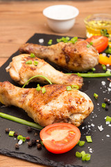 Fried chicken legs garnish cherry tomato and bunch-onion