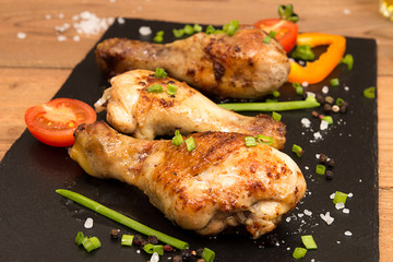Fried chicken legs garnish cherry tomato and bunch-onion