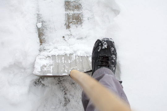 Using A Snow Shovel In A Snowed Yard