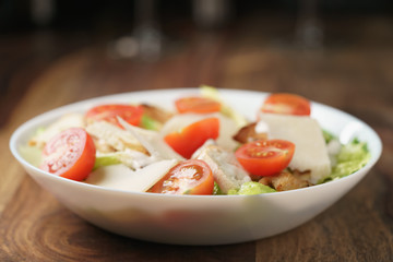 fresh homemade caesar salad with chicken, shallow depth of field
