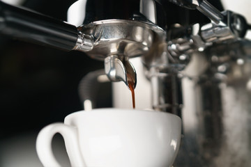 coffee extraction process from professional espresso machine, shallow focus