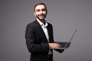 Young businessman in suit with laptop in hands  isolated