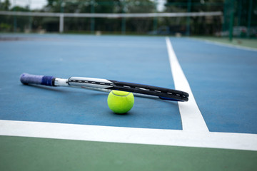 Tennis Ball and Racket on tennis court
