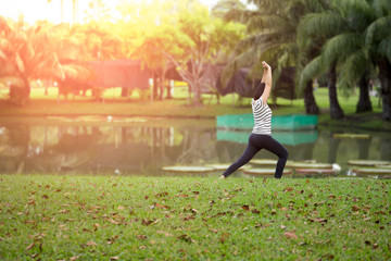 Obraz na płótnie Canvas Unidentified woman doing yoga in morning