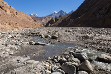 road over a stream in mountain gorge