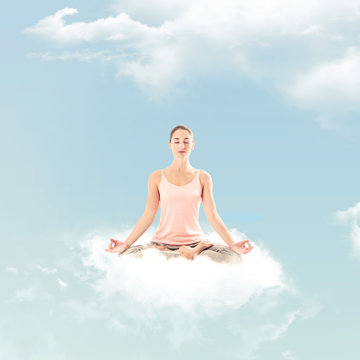 Woman doing a yoga posture on a cloud: Meditation posture - Lotus - Padmasana
