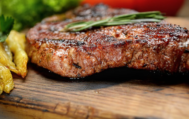 grilled juicy steak with rosemary. 