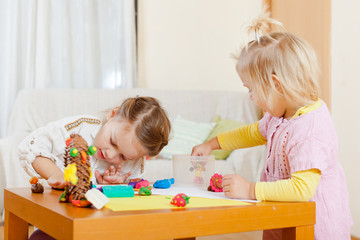  Preschoolers molding figurines from plasticine .