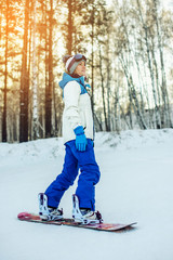 female snowboarder snowboarding down the mountain