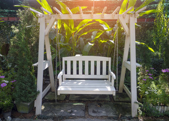 white wooden porch swing in garden
