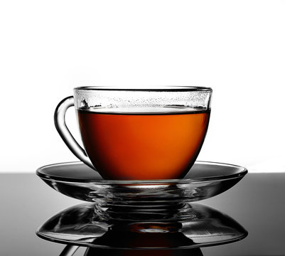 cup of hot tea on the mirror surface