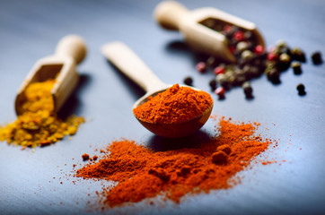 Colorful spices on a dark blue table. Vegetable. Concept of kitchen and cooking. Spicy on a wooden...