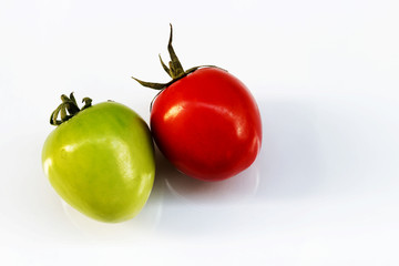 Green tomatoes with tomato red on a white background.