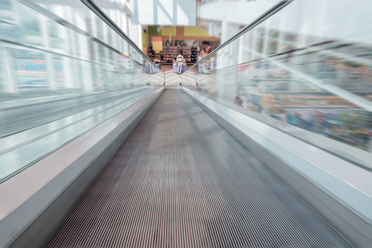 Escalator / View of empty escalator in shopping mall. Movement. Shallow depth of field.