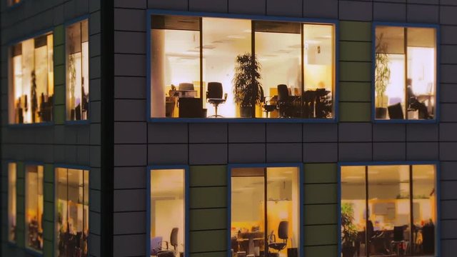 Windows light up in the house. Fragment of the layout of the building