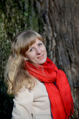 Portrait of the young fair-haired woman against the background o