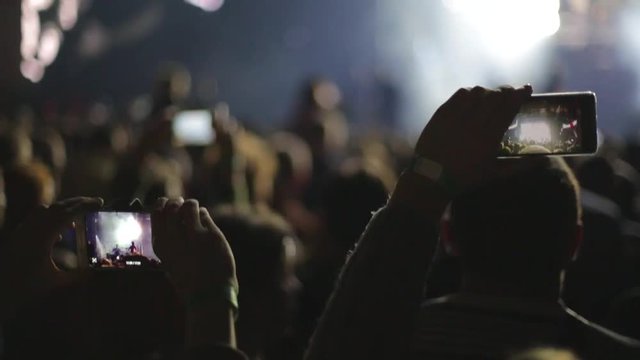 Making video with smartphone at live music concert, slow-motion