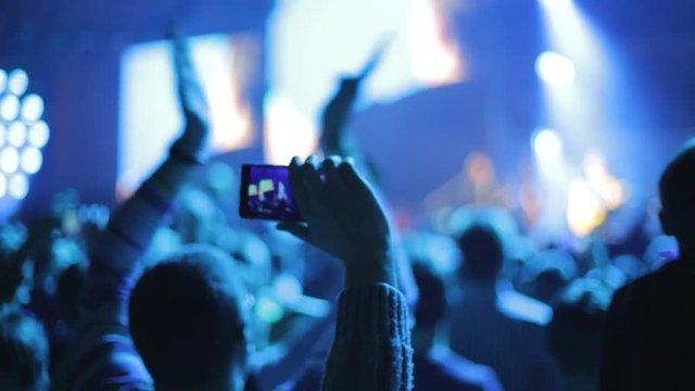 Making video with smartphone at live music concert, applause, slow-motion