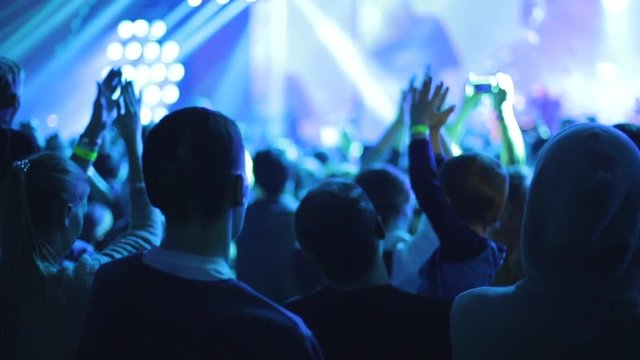 People applaud on live music concert, slow-motion